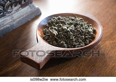 Tea leaves in wooden bowl View Large Photo Image Stock Photo - Tea leaves in wooden bowl. Fotosearch
