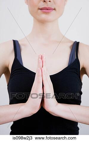 Woman in prayer position during yoga View Large Photo Image Stock Image - Woman in prayer position during yoga. Fotosearch