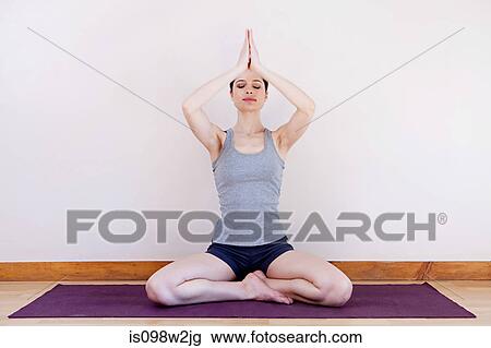 Woman in prayer position during yoga View Large Photo Image Stock Image - Woman in prayer position during yoga. Fotosearch