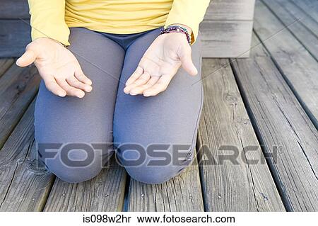 Woman kneeling palms open View Large Photo Image Stock Photography - Woman kneeling palms open. Fotosearch