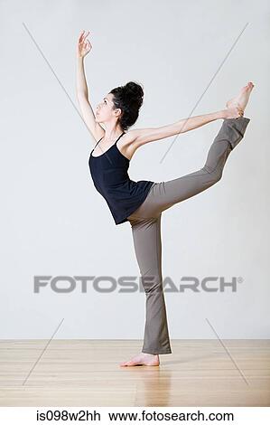 Stock Image - Woman practicing yoga. Fotosearch