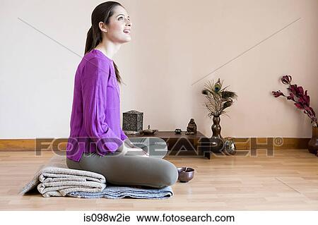 Woman sitting cross legged with teacup on floor View Large Photo Image Stock Image - Woman sitting cross legged with teacup on floor. Fotosearch