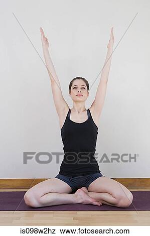 Stock Photo - Woman stretching during yoga. Fotosearch