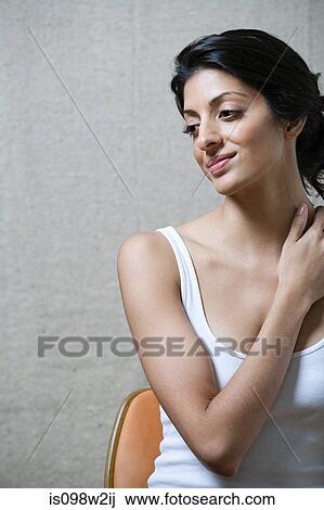 Stock Image - Woman touching neck. Fotosearch