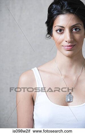Woman wearing silver pendant looking at camera View Large Photo Image Stock Image - Woman wearing silver pendant looking at camera. Fotosearch