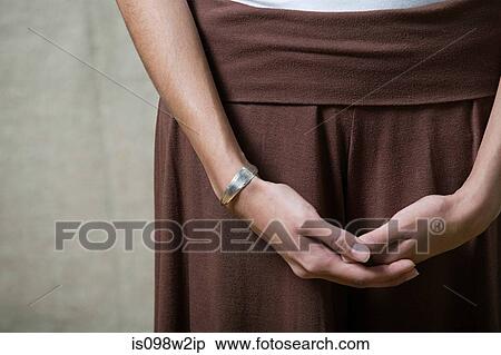 Stock Photography - Woman with hands clasped, close up. Fotosearch
