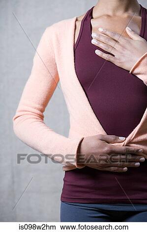 Picture - Women breathing deeply, touching chest and abdomen. Fotosearch