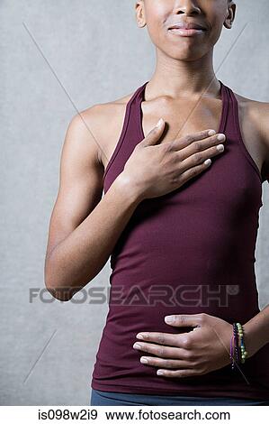 Women breathing deeply, touching chest and abdomen View Large Photo Image Stock Photo - Women breathing deeply, touching chest and abdomen. Fotosearch