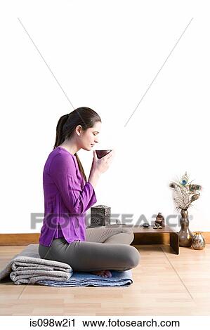 Stock Image - Women drinking herbal tea. Fotosearch