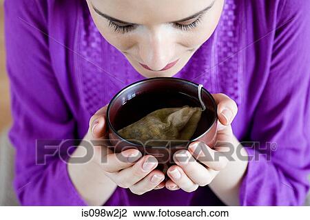 Stock Image - Women drinking herbal tea. Fotosearch