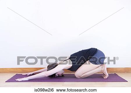 Stock Photograph - Women in child pose during yoga. Fotosearch