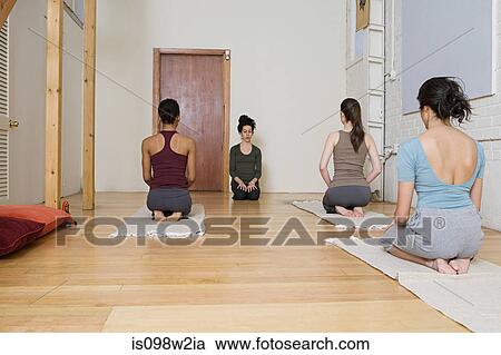 Stock Image - Women practising yoga. Fotosearch