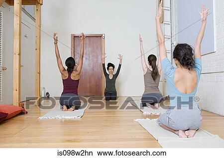 Picture - Women stretching during yoga. Fotosearch