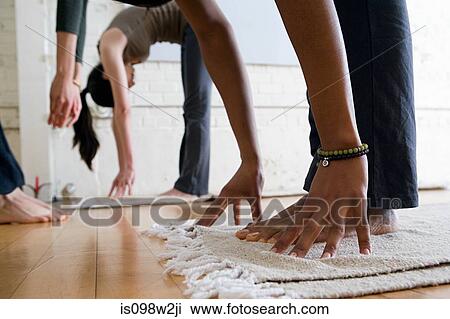 Women stretching during yoga View Large Photo Image Stock Image - Women stretching during yoga. Fotosearch