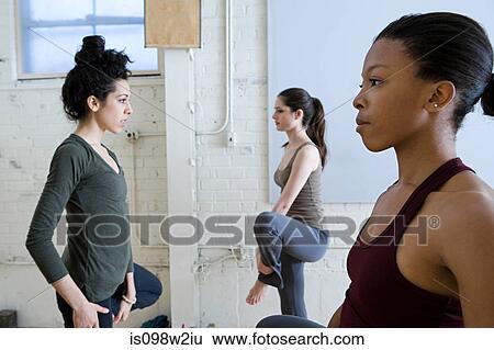 Stock Photograph - Women stretching during yoga. Fotosearch