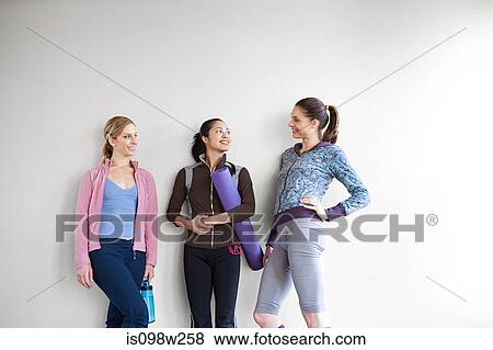 Three women in dance studio standing by wall View Large Photo Image Stock Photo - Three women in dance studio standing by wall. Fotosearch
