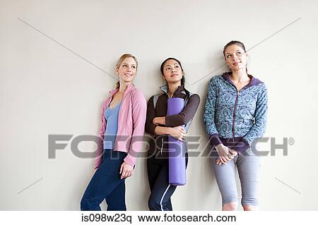 Three women in dance studio standing by wall View Large Photo Image Stock Photography - Three women in dance studio standing by wall. Fotosearch
