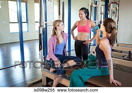 Stock Photography - Three women in gym talking. Fotosearch
