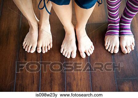 Three women standing on wooden floor View Large Photo Image Stock Photo - Three women standing on wooden floor. Fotosearch