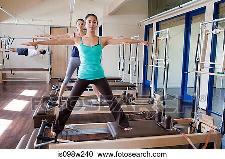 Two women doing pilates in gym View Large Photo Image Stock Image - Two women doing pilates in gym. Fotosearch