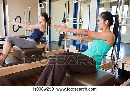 Two women doing pilates View Large Photo Image Stock Photo - Two women doing pilates. Fotosearch