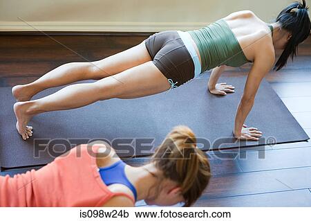 Two women doing yoga class View Large Photo Image Stock Image - Two women doing yoga class. Fotosearch