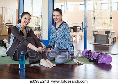 Two women sitting in gym resting View Large Photo Image Stock Image - Two women sitting in gym resting. Fotosearch