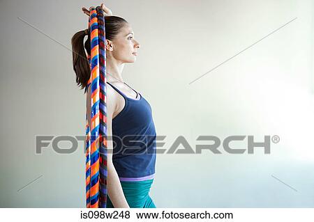 Stock Photo - Woman holding plastic hoop for pilates. Fotosearch
