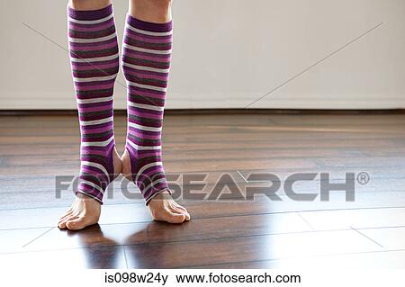 Stock Photo - Woman wearing stripey legwarmers on tiptoe. Fotosearch
