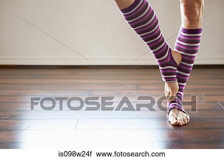 Woman wearing stripey legwarmers standing on one leg View Large Photo Image Stock Image - Woman wearing stripey legwarmers standing on one leg. Fotosearch