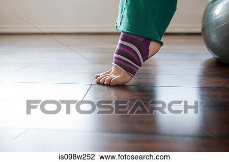 Women wearing stripey legwarmers on exercise ball View Large Photo Image Stock Image - Women wearing stripey legwarmers on exercise ball. Fotosearch