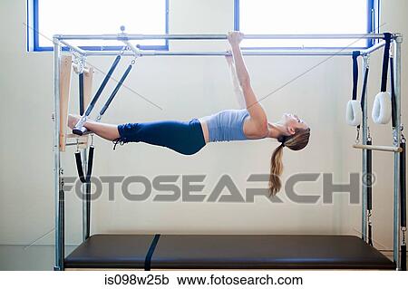 Young woman doing pilates View Large Photo Image Stock Image - Young woman doing pilates. Fotosearch