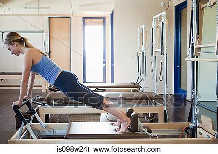 Young woman doing pilates View Large Photo Image Stock Photograph - Young woman doing pilates. Fotosearch