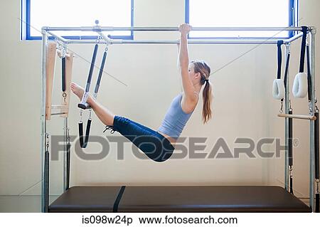 Young woman doing pilates View Large Photo Image Stock Photography - Young woman doing pilates. Fotosearch