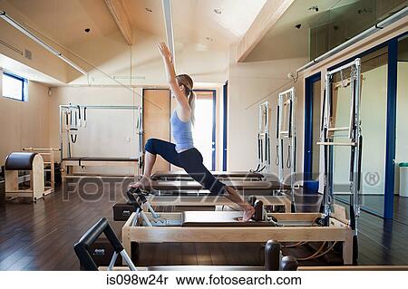 Stock Photography - Young woman doing pilates. Fotosearch