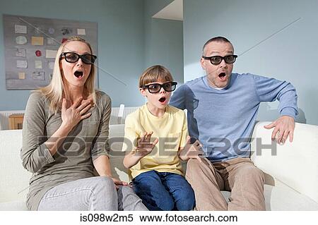 Stock Photography - Family watching 3d movie at home. Fotosearch