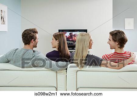 Stock Image - Two couples watching television. Fotosearch