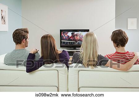 Two couples watching television View Large Photo Image Stock Image - Two couples watching television. Fotosearch