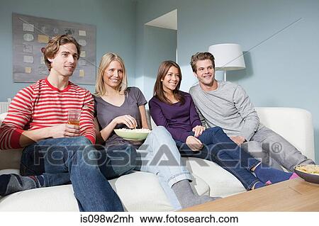Stock Image - Two young couples watching television. Fotosearch