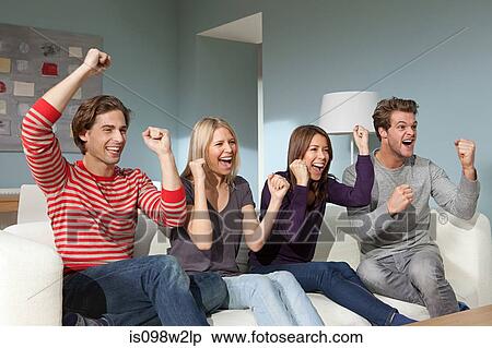 Stock Photography - Two young couples watching television. Fotosearch