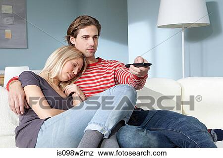 Young couple watching television, woman sleeping View Large Photo Image Stock Photo - Young couple watching television, woman sleeping. Fotosearch