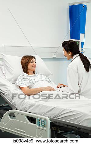 Female patient with doctor View Large Photo Image Stock Photo - Female patient with doctor. Fotosearch