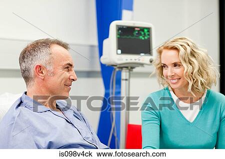 Stock Image - Wife visiting husband in hospital. Fotosearch