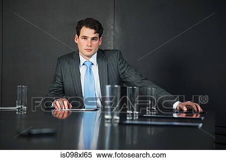 Businessman in conference room with documents View Large Photo Image Stock Photography - Businessman in conference room with documents. Fotosearch