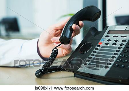 Office worker answering telephone View Large Photo Image Stock Image - Office worker answering telephone. Fotosearch