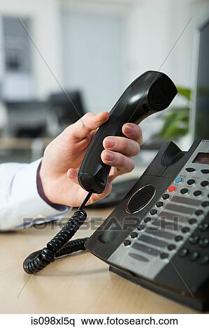 Office worker answering telephone View Large Photo Image Stock Photography - Office worker answering telephone. Fotosearch
