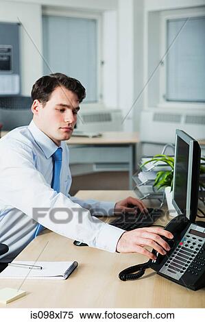 Office worker answering telephone View Large Photo Image Stock Photography - Office worker answering telephone. Fotosearch