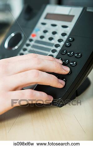 Office worker dialling telephone View Large Photo Image Stock Photo - Office worker dialling telephone. Fotosearch