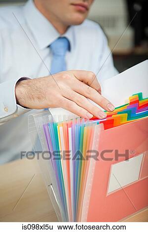 Stock Photograph - Office worker filing document. Fotosearch