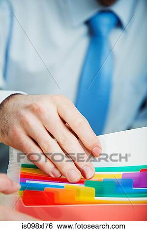Stock Photograph - Office worker filing document. Fotosearch